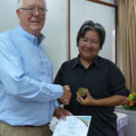 Prof Rerkasem receives the medal from Dr Eric Craswell, Director of Training
